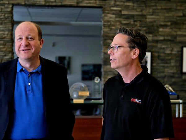 Colorado Governor Polis meets with Geotech CEO Jeff Popiel in the entry lobby at Geotech's Headquarters in Denver